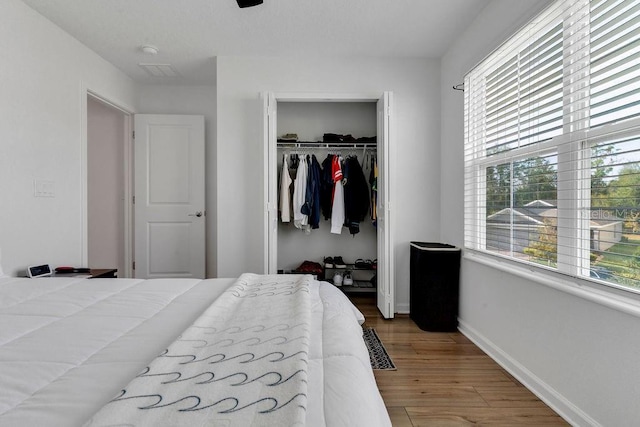 bedroom featuring hardwood / wood-style flooring and a closet