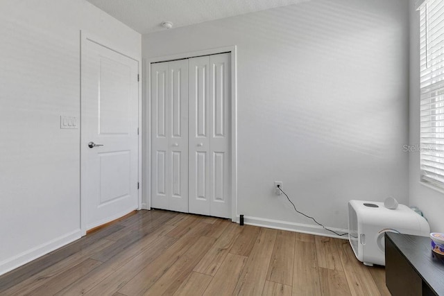 bedroom with a closet and light wood-type flooring