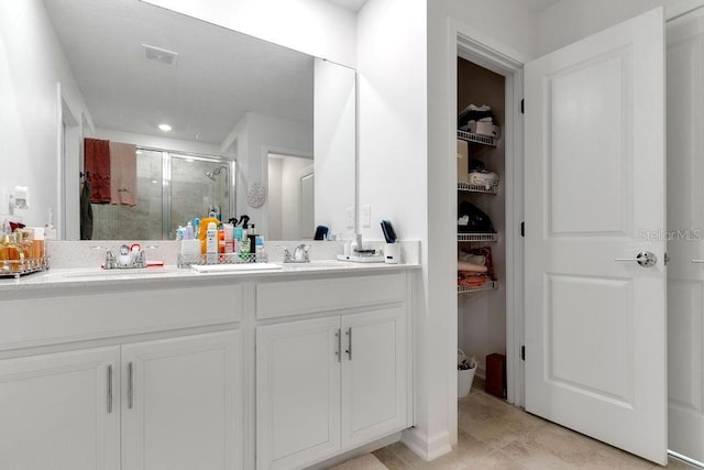 bathroom with vanity, tile patterned floors, and an enclosed shower