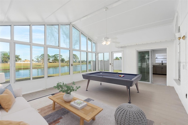 playroom with ceiling fan, a healthy amount of sunlight, a water view, and pool table