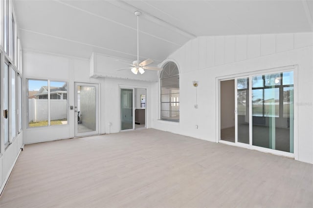 interior space featuring vaulted ceiling with beams, ceiling fan, and plenty of natural light