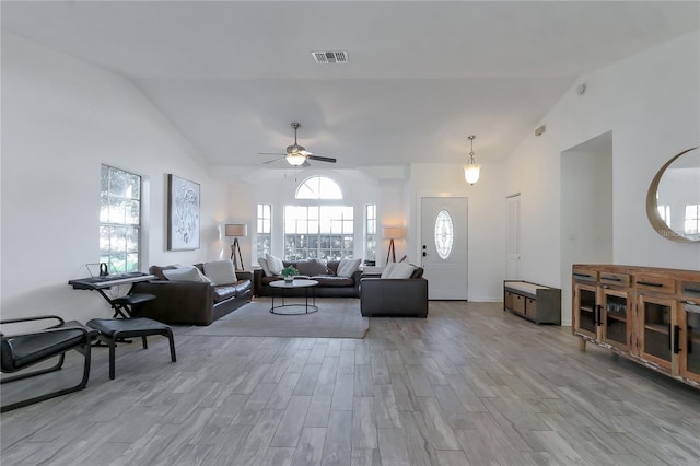 living room with ceiling fan and vaulted ceiling