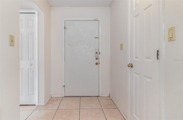 entryway with light tile patterned floors