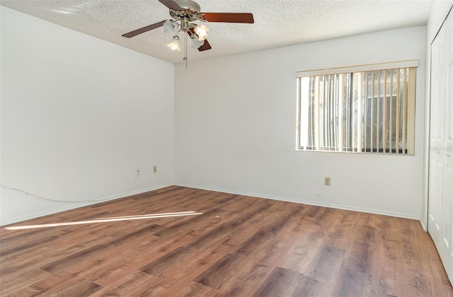spare room with wood-type flooring, a textured ceiling, and ceiling fan