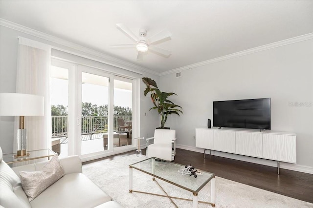 living room featuring ceiling fan, wood-type flooring, and ornamental molding