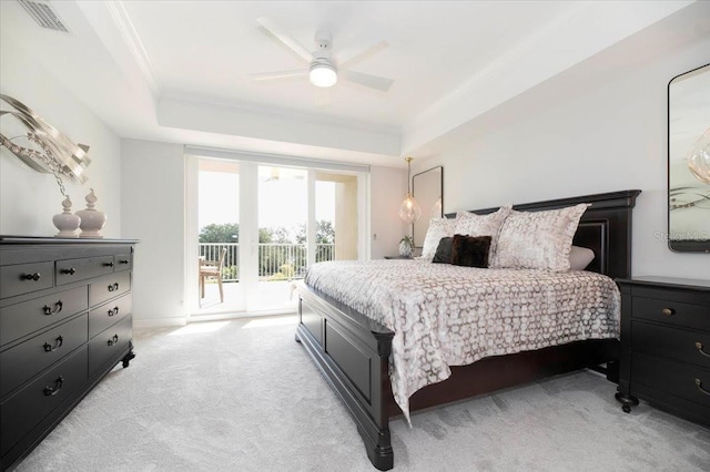 carpeted bedroom featuring ceiling fan, crown molding, a raised ceiling, and access to outside