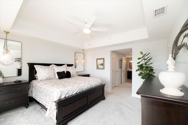 bedroom with ceiling fan, light colored carpet, crown molding, and a raised ceiling