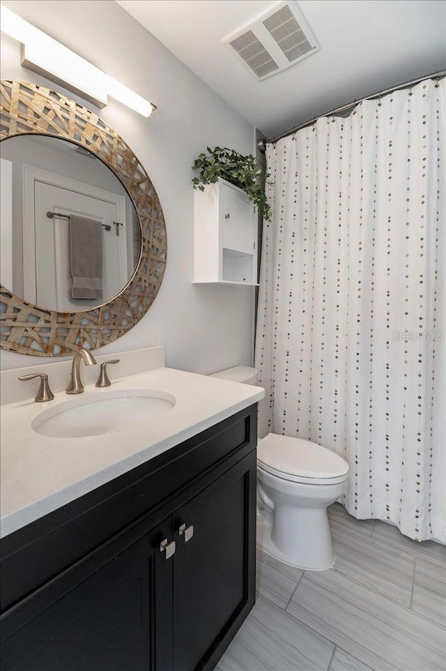 bathroom featuring toilet and vanity