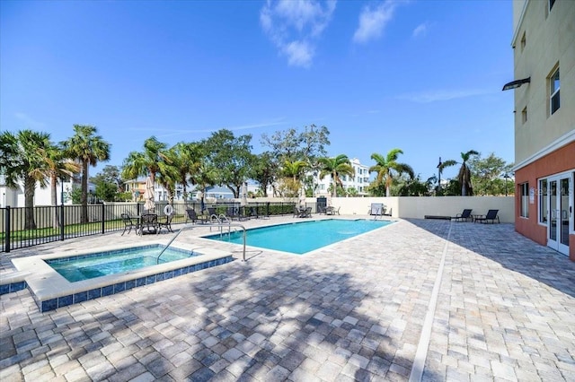 view of pool with a community hot tub and a patio