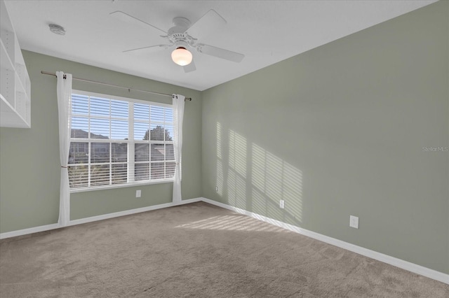 empty room featuring carpet and ceiling fan