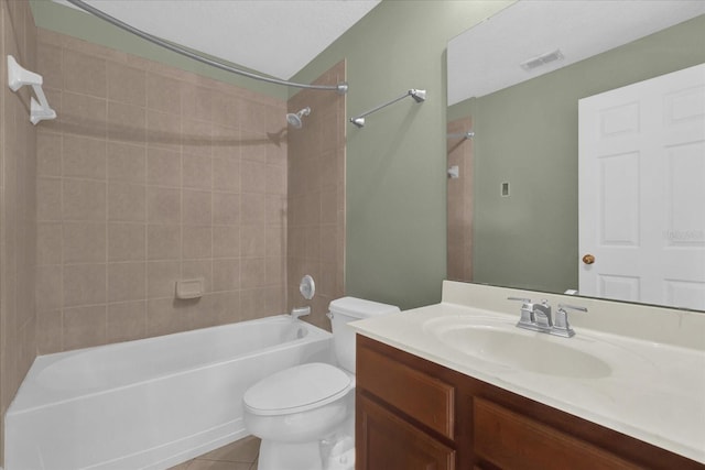 full bathroom featuring vanity, tiled shower / bath combo, tile patterned floors, and toilet