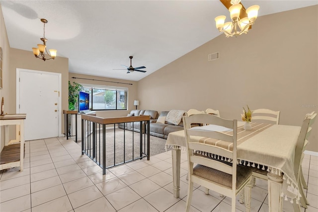 dining room with light tile patterned floors, ceiling fan with notable chandelier, and lofted ceiling