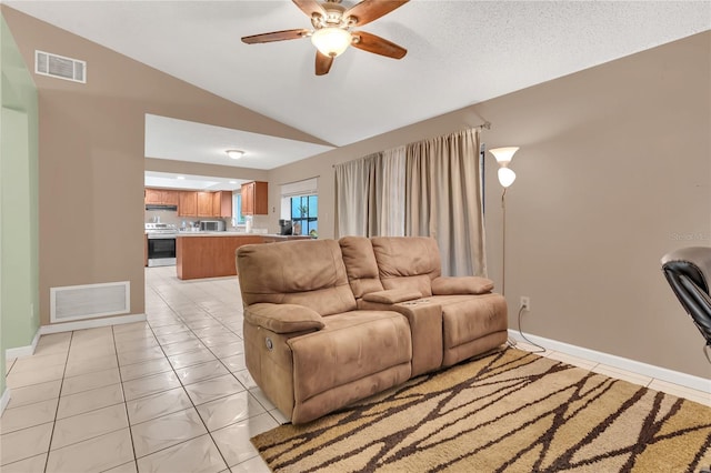 tiled living room featuring vaulted ceiling and ceiling fan