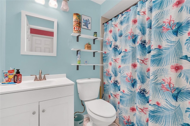 bathroom with vanity, a shower with shower curtain, and toilet