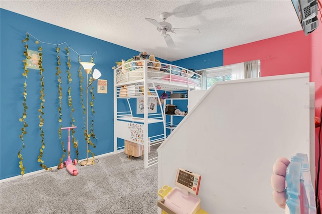 carpeted bedroom with ceiling fan and a textured ceiling