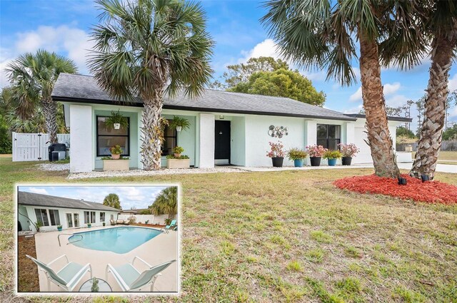 exterior space with a yard and a fenced in pool