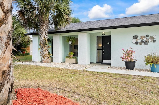 property entrance with a yard