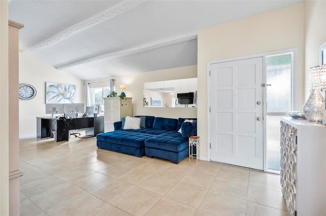 tiled living room with plenty of natural light and lofted ceiling