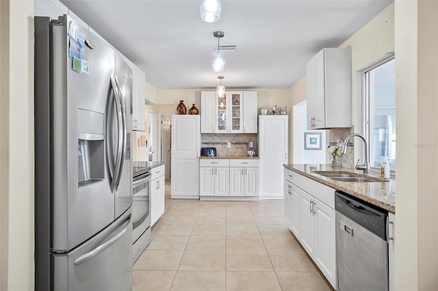 kitchen with white cabinets, appliances with stainless steel finishes, backsplash, and sink