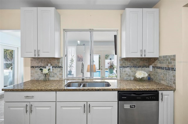 kitchen featuring tasteful backsplash, dishwasher, white cabinets, and sink