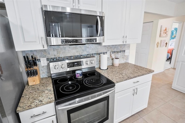 kitchen with backsplash, white cabinetry, light tile patterned flooring, and stainless steel appliances