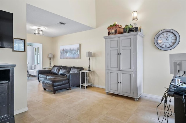 living room with light tile patterned flooring and a textured ceiling