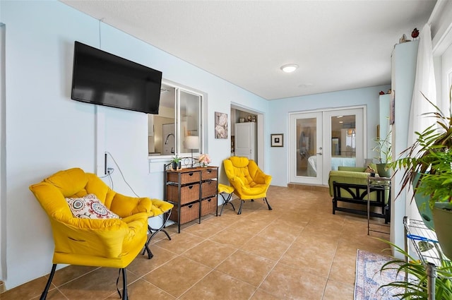 living area featuring light tile patterned flooring and french doors