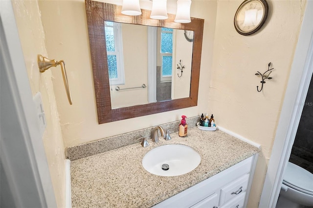 bathroom with vanity and toilet