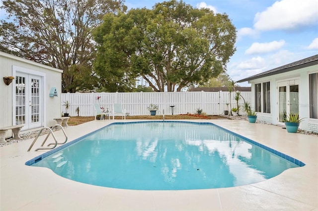 view of swimming pool featuring a patio area and french doors