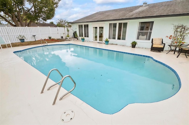 view of pool with french doors