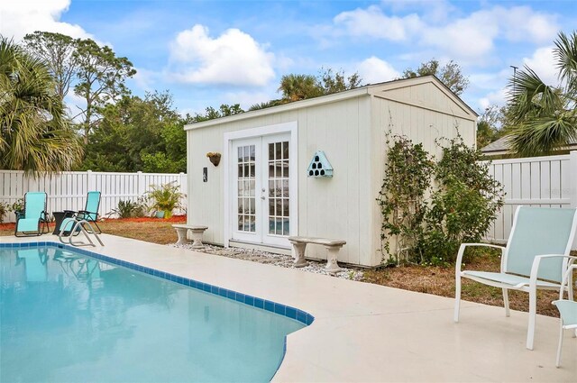 view of pool featuring a patio area and an outbuilding