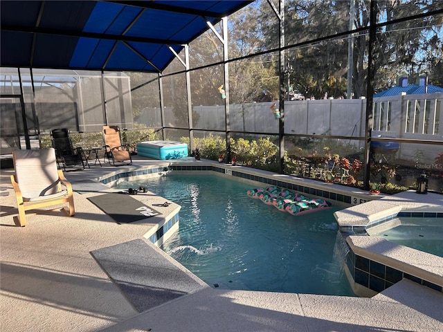 view of pool with a lanai, a patio area, and an in ground hot tub