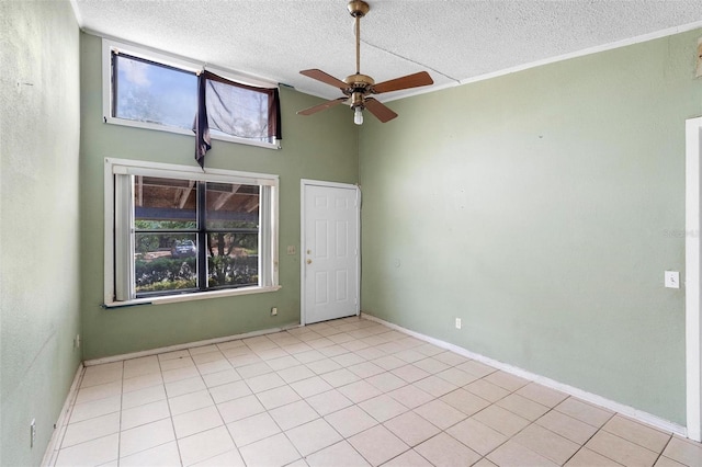 tiled spare room featuring ceiling fan and a textured ceiling