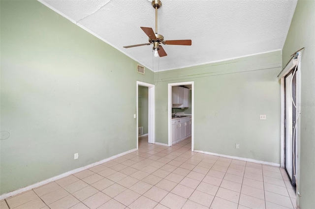 unfurnished bedroom with ceiling fan, light tile patterned floors, and a textured ceiling