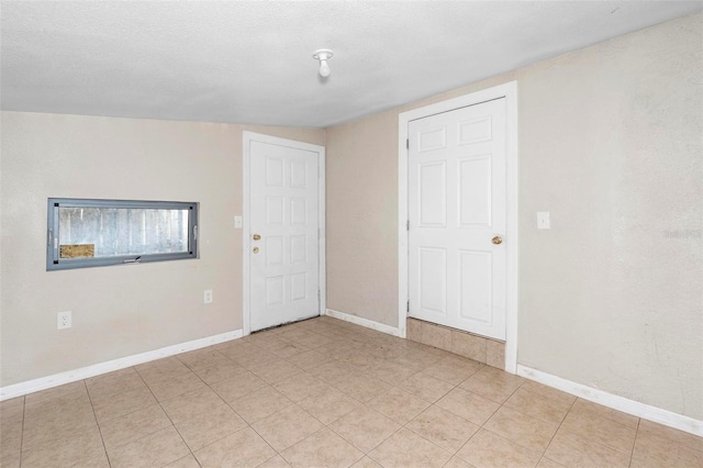 unfurnished room featuring a textured ceiling