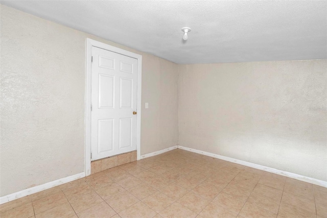 empty room featuring a textured ceiling