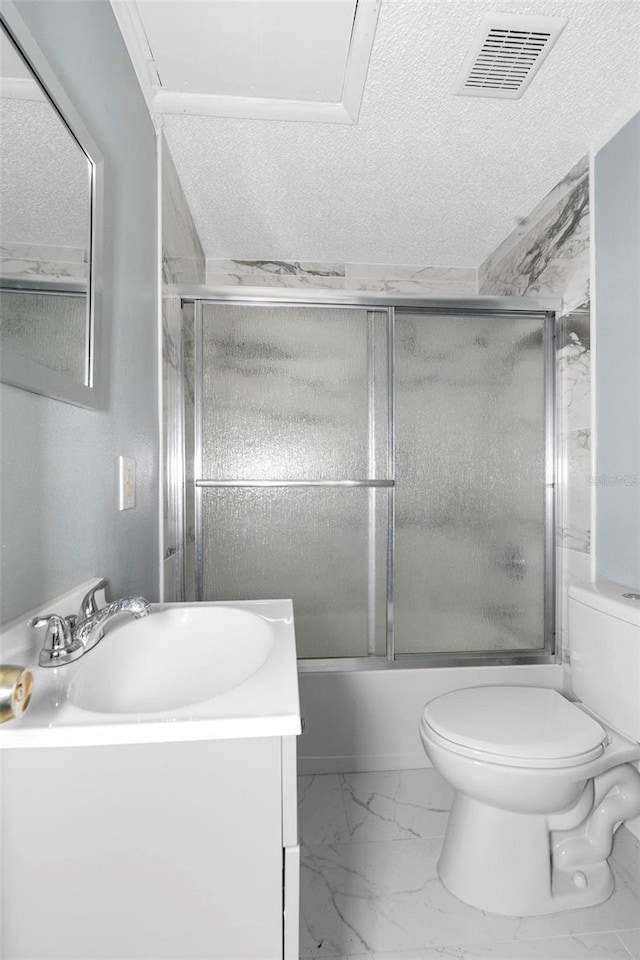 full bathroom featuring a textured ceiling, vanity, toilet, and enclosed tub / shower combo