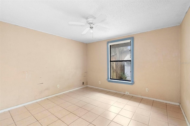 tiled empty room featuring ceiling fan and a textured ceiling