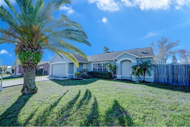 view of front of house featuring a garage and a front lawn