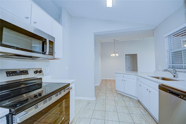 kitchen featuring vaulted ceiling, pendant lighting, white cabinetry, sink, and stainless steel appliances