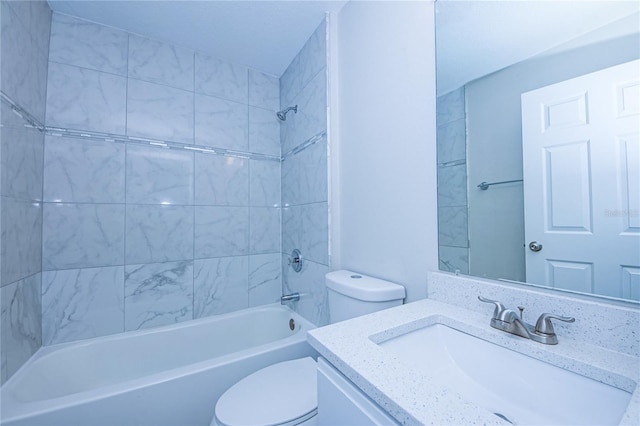 full bathroom featuring tiled shower / bath combo, vanity, and toilet