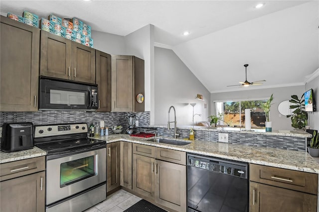 kitchen with ceiling fan, sink, light stone counters, vaulted ceiling, and black appliances