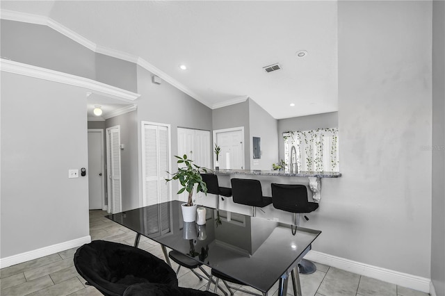 dining room with visible vents, ornamental molding, recessed lighting, baseboards, and vaulted ceiling