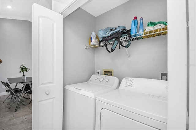 washroom featuring laundry area, baseboards, and separate washer and dryer