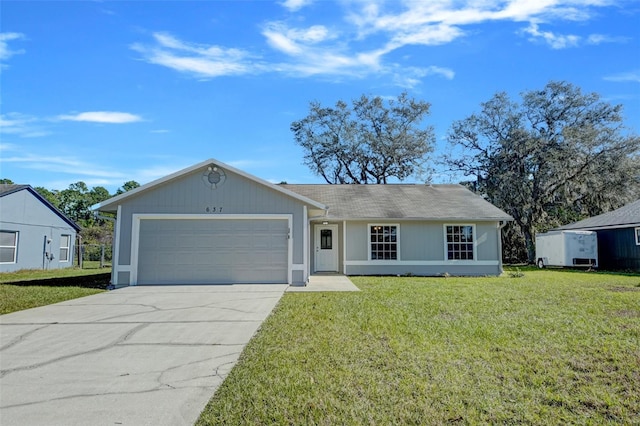 single story home featuring a garage and a front lawn