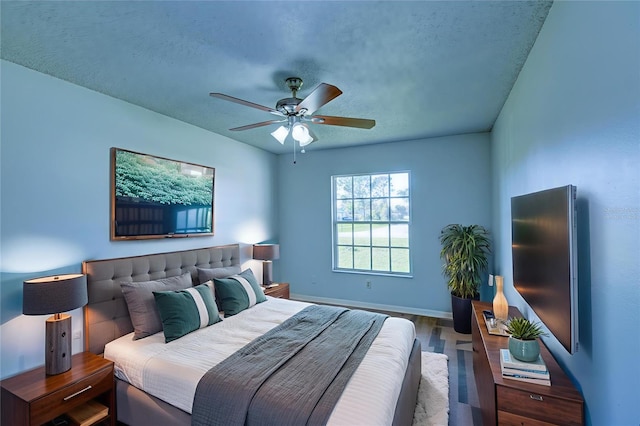 637 Twin Lake Ave, Deltona, FL 32738 - bedroom featuring wood finished floors, a textured ceiling, and a ceiling fan