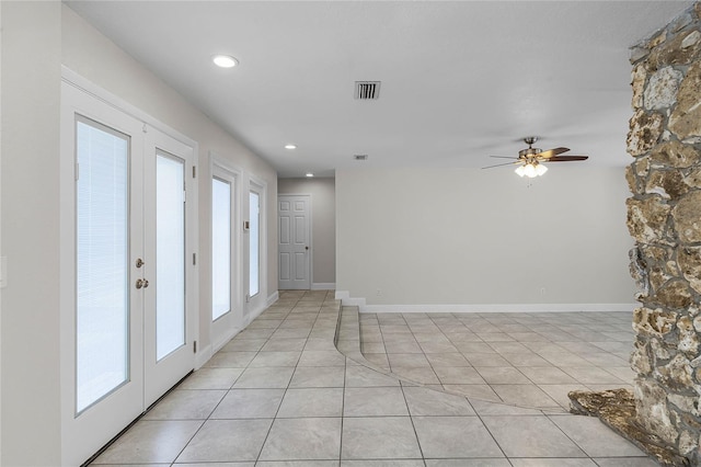 spare room with light tile patterned floors, baseboards, visible vents, and french doors