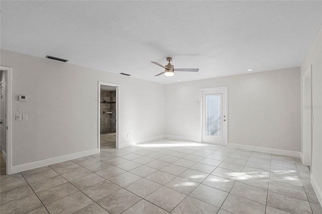 empty room featuring visible vents, ceiling fan, baseboards, and light tile patterned flooring