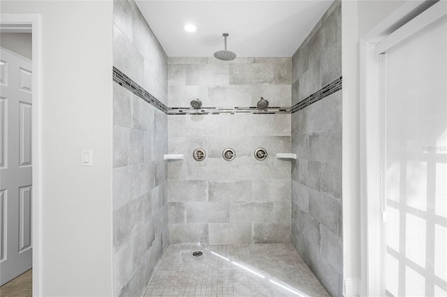 bathroom with a tile shower