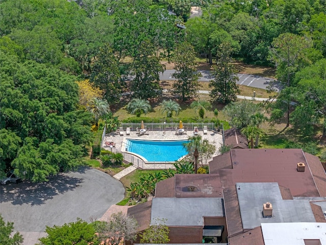 pool with a patio and fence